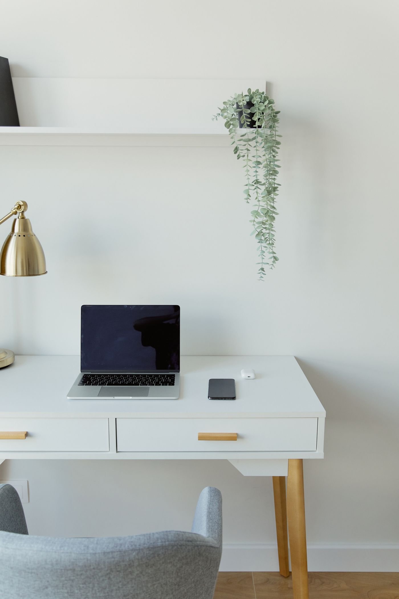 Laptop and smartphone on a white desk — illustrative photograph